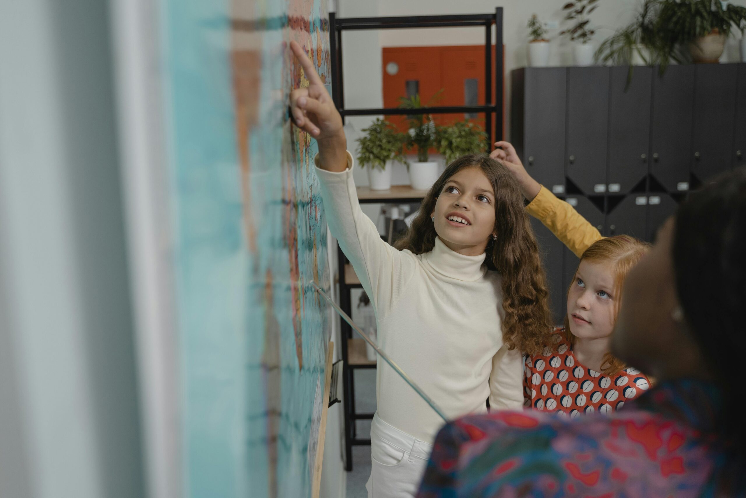 Children actively participate in a geography lesson in a school classroom.